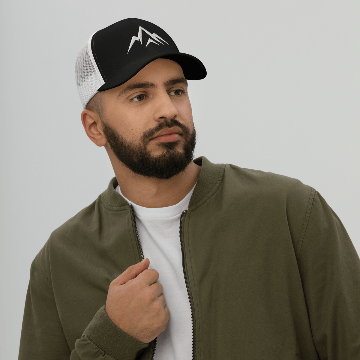 Man wearing Unshaken Apparel Logo Trucker Hat, representing strength and faith in God through athletic style.