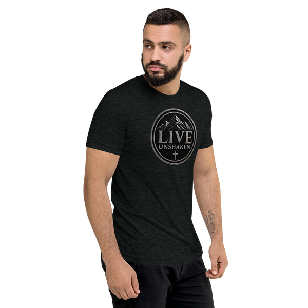 Man modeling the Live Unshaken Mountain Emblem T-Shirt symbolizing faith in God, perfect Christian apparel.