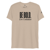 Be Bold. Live Unshaken T-Shirt in tan triblend, featuring strong lettering and a gold cross, promoting faith and Christian values.